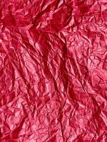Crushed red paper texture, red background photo