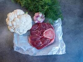 Raw Beef Shank with Bone Fresh Vegetabl on Parchment Paper photo