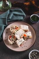 Flat bread rolls with chicken and vegetables on a plate on the table vertical view photo