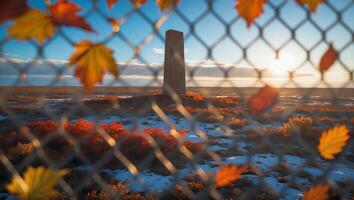Viewing Monument Through Fence with Autumn Leaves on Snowy Landscape photo