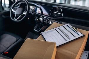 Notepad on boxes in the car, conception of delivery.. photo