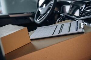 Notepad on boxes,, in the car, conception of delivery photo