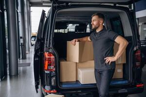 Bunch of boxes., Delivery man or loader is near the car photo