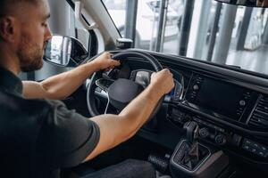 Man, is sitting in the car, driver. photo