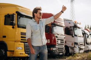Friendly ,hand ,,gesture. Truck driver is near the transport outdoors photo