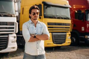 Cool ,look, in sunglasses. ..Truck driver is near the transport outdoors photo