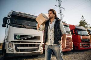 Delivery is on the way, ,,with ,box. Truck driver is near the transport outdoors photo