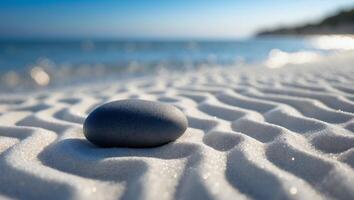 Stone Resting on Patterned Sand Near Ocean Shoreline Offers Calm photo