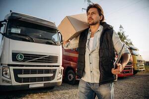 Delivery, is, on the way, with box. Truck ,,driver is near the transport outdoors photo