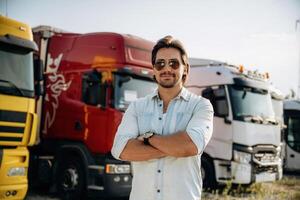 Many, of ,,the trucks are parked. driver is near the transport outdoors photo
