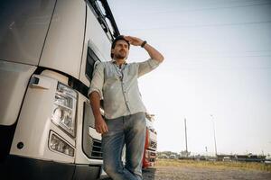 View, from, below,, standing, and posing. Truck driver is near the transport outdoors photo