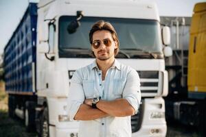 Standing with arms crossed... Truck driver is near the transport outdoors photo