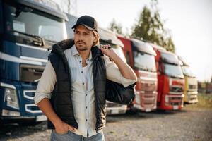 Model ,in ,,cap is posing. Truck driver is near the transport outdoors photo