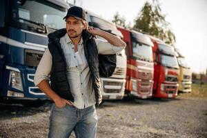 Model, in,, cap is posing. Truck driver, is, near the transport outdoors photo