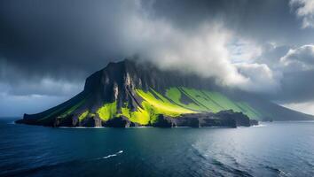 Island Mountain Covered in Clouds with Lush Greenery and Blue Ocean photo