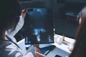 Two doctors looking at a x - ray image on a computer photo