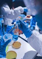 A person in a lab coat and gloves is working on a project photo