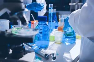 A laboratory with several bottles and a microscope photo