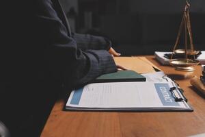Lawyer working at desk with papers and books photo