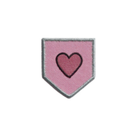 Pink embroidered patch with heart design in center, featuring silver border. patch is shaped like shield and has textured fabric appearance, conveying sense of warmth and affection png