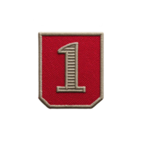 Red embroidered patch with number one in center, outlined in gold thread, symbolizing achievement or rank. patch has shield like shape and textured fabric surface png