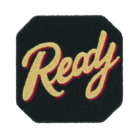Image features patch with word Ready embroidered bold, cursive lettering. text is golden color with red outline, set against transparency background, giving it vintage and motivational feel png