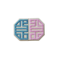 This shows embroidered patch with geometric design, featuring blue and pink sections. pattern is symmetrical and intricate, creating visually appealing contrast.embroidered patch with geometric png