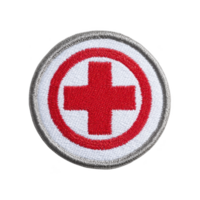 Circular embroidered patch features red cross symbol on transparency background, bordered by gray edge, representing medical aid or first aid png