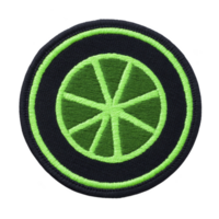 This features circular embroidered patch with green wheel design transparency background, symbolizing movement or transportation. vibrant green color adds modern touch.circular embroidered patch png
