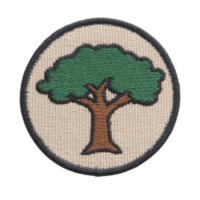 Round embroidered patch features green tree with brown trunk on beige background, bordered by dark edge. design is simple and nature themed png