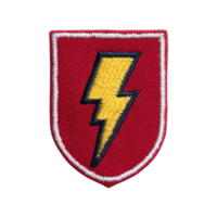 This shows red shield shaped patch with yellow lightning bolt in center, outlined in black and white. patch has bold and striking design.lightning bolt patch on red shield with white border png