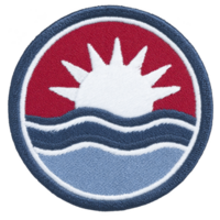 This shows circular embroidered patch featuring stylized sun rising over waves, with red background. design is simple and bold, using white, blue, and red colors png