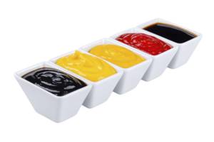 A four square white bowls filled with different sauces are arranged in line, featuring black, yellow, red, and brown sauces. vibrant colors create appetizing display png