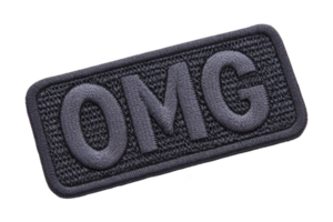 A rectangular embroidered patch with letters omg in bold, dark stitching on textured background, conveying surprise or excitement png