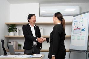 Professional Networking and Agreement. Business partners shaking hands in a modern office setting. photo
