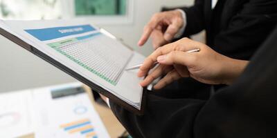 Data Review and Strategy Development. Business professionals analyzing financial data together. photo
