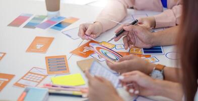 Team of Designers Collaborating. Professionals discussing layout concepts and color selections at a creative workspace. photo