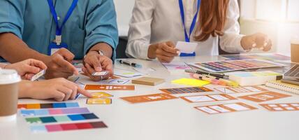 Design Professionals Collaborating on Concepts. Team discussing layout designs and color choices in a creative setting. photo