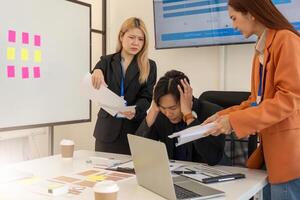 Workplace Stress and Problem Solving. Professionals addressing project issues in a busy office environment. photo