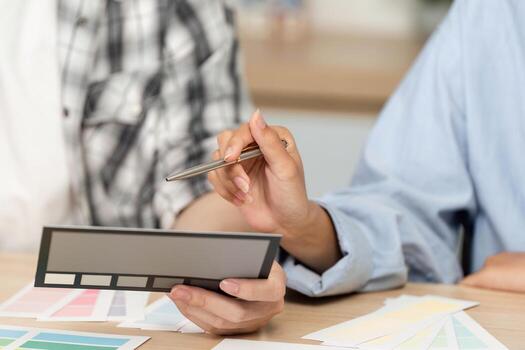 UX and UI Design Focus. Close-up of hands analyzing color swatches for a project. photo