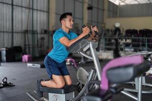 Fitness Enthusiast. Man performing workout on elliptical machine. photo