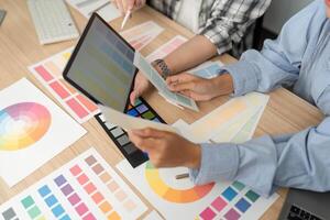 UX and UI Design Review. Designers analyzing color palettes and digital concepts. photo