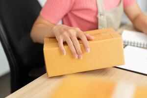 Small Business Operations. A woman handling packages in a microbusiness setting. photo