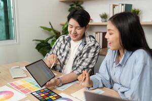 Collaborative UX and UI Design Session. Designers reviewing ideas on a tablet. photo