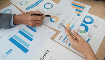 Analyzing Financial Data. Close-up of hands reviewing charts and graphs during a business meeting. photo