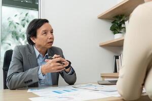 Engaging Business Discussion. A businessman conversing with a colleague while reviewing financial data. photo