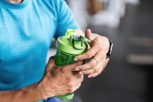 Hydration and Fitness. Close-Up of Man with Shaker Bottle photo
