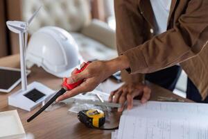 ESG Principles in Action. Architect measuring dimensions for a sustainable project. photo