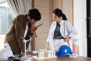 ESG Implementation. Architects discussing sustainable design using advanced tools. photo
