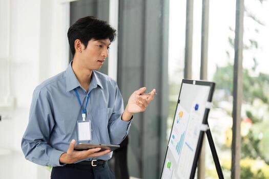 Data Analysis and Presentation Skills. Young professional reviewing charts while on a call. photo